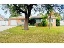 Charming single-story home featuring a well-manicured lawn and an attached garage at 6315 25Th N Ave, St Petersburg, FL 33710