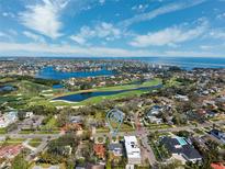 Scenic aerial view of a neighborhood with a golf course and waterfront, pinpointing the property location at 735 Snell Isle Ne Blvd, St Petersburg, FL 33704