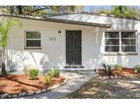 Close-up of front entrance with brick walk way and well-kept landscaped at 1212 E Crawford St, Tampa, FL 33604