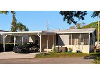 Cozy single-story home with a carport and a screened-in porch for comfortable outdoor living at 1668 Mary Ln # 341, Lutz, FL 33558