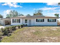 Charming single-story home with a well-maintained lawn, solar panels, and inviting curb appeal at 2007 Yale Ave, Bradenton, FL 34207