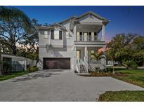 Charming two-story home featuring a welcoming front porch and a spacious two-car garage at 3201 S Manhattan Ave, Tampa, FL 33629