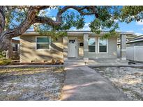 Charming single story home with tan brick, a welcoming front porch, and lush tree providing shade at 3711 1St S Ave, St Petersburg, FL 33711