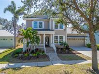 Charming two-story home with well-manicured landscaping and a welcoming front porch at 410 Manns Harbor Dr, Apollo Beach, FL 33572