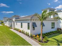 Charming single-story home showcasing a lush front yard with a beautiful palm tree and well-maintained landscaping at 5932 Red Mangrove Ln, Bradenton, FL 34210
