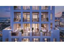 Luxury condo building showcasing balconies with outdoor furniture and city views at twilight at 126 4Th Ne Ave # 2201, St Petersburg, FL 33701