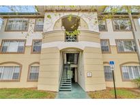 Condo building exterior featuring an arched entryway, stairwell, and decorative accents at 17108 Carrington Park Dr # 701, Tampa, FL 33647