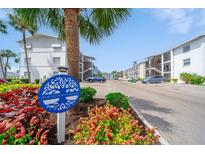 A view of the Fourth Bayshore community showing beautiful landscaping and white buildings under a bright blue sky at 2113 Canal Dr # B2, Bradenton, FL 34207