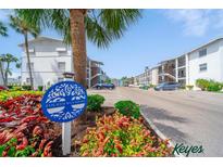 Condominium complex with mature landscaping and plentiful parking on a bright, sunny day at 2113 Canal Dr # B2, Bradenton, FL 34207