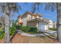 Inviting two-story condo with a terracotta tile roof, neutral stucco and manicured landscaping at 236 Valencia Cir, St Petersburg, FL 33716