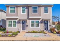 Inviting two-story townhome featuring a neutral-toned facade, well-manicured landscaping, and individual front entrances at 3601 1St S Ave, St Petersburg, FL 33711