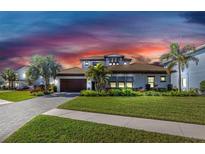 Beautiful single-story home with a paver driveway, lush landscaping and a 2-car garage at 4054 Rocky Shores Dr, Tampa, FL 33634