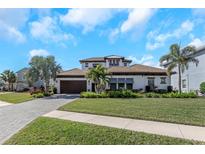 Beautiful single-Gathering home with a well-manicured lawn and tropical landscaping at 4054 Rocky Shores Dr, Tampa, FL 33634