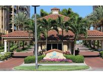 Belle Harbor entrance with tropical plants and a guard house, creating a secure community at 501 Mandalay Ave # 601, Clearwater Beach, FL 33767