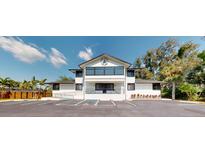 Modern two-story building featuring expansive windows, a well-maintained landscape, and convenient parking at 10787 Oak Ne St, St Petersburg, FL 33716