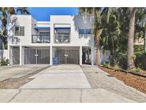 Contemporary two-story townhome boasting gated carports and charming blue awnings over the second story balconies at 3117 W Barcelona St # A, Tampa, FL 33629