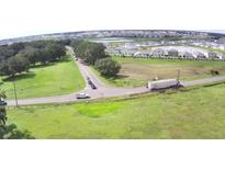 Community aerial view showing surrounding green space and pond views at 32817 Leonard Rd, San Antonio, FL 33576