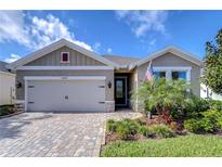 Charming single-story home with a brick driveway, well-maintained landscaping, and a two-car garage at 6113 Plover Meadow St, Lithia, FL 33547