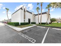 Beautiful exterior view of the condo with palm trees, manicured shrubs, and reserved parking spot at 711 Russell Ln # 238, Brandon, FL 33510