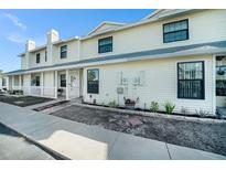 Inviting two-story condo with a charming front porch and well-maintained landscaping at 12709 Raeburn Way, Tampa, FL 33624