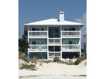 Three story beach house with white balconies overlooking beach at 712 Beach Trl # C, Indian Rocks Beach, FL 33785