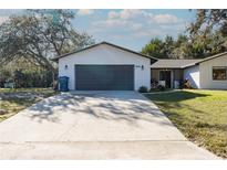 Charming single-story home featuring an attached garage and well-maintained front lawn at 8436 Cameo St, Spring Hill, FL 34608