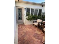 Inviting patio with brick flooring, comfortable seating and lush greenery, perfect for outdoor relaxation at 16103 4Th E St, Redington Beach, FL 33708