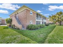 Well-maintained brick condo building with screened in balcony overlooking lush green lawn at 3847 35Th S Way # 108, St Petersburg, FL 33711