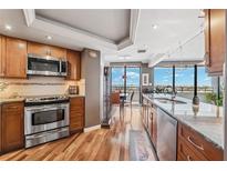 Well-equipped kitchen boasts wood cabinets, stainless steel appliances, and expansive windows with breathtaking water views at 5950 Pelican Bay S Plz # Ph-2F, Gulfport, FL 33707
