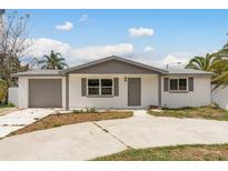 Charming single-story home with a well-maintained front yard and attached garage at 9321 Gray Fox Ln, Port Richey, FL 34668