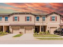 Beautiful townhome featuring neutral stucco, red shutters, covered entryway, and well-kept landscaping at 11903 Castine St, New Port Richey, FL 34654