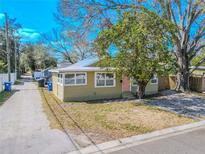 Charming single-story home with a well-maintained lawn and inviting pink front door at 1800 27Th N Ave, St Petersburg, FL 33713