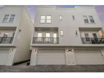 Modern townhome boasts a balcony, two-car garage, and sleek architectural design at 3505 S Macdill Ave # 4, Tampa, FL 33629