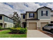 Charming two-story townhome with a well-maintained lawn and attached garage, offering modern curb appeal at 17567 Nectar Flume Dr, Land O Lakes, FL 34638