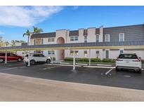 Building exterior showing carports and landscaping at 210 Fernwood Cir # 210, Seminole, FL 33777