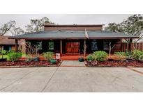 Charming exterior features wood accents, manicured landscaping, and a welcoming entrance at 22819 Southshore Dr, Land O Lakes, FL 34639