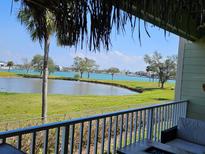 Enjoy beautiful views of the lush lawn and sparkling pond from this relaxing balcony space at 530 Sandy Hook Rd, Treasure Island, FL 33706