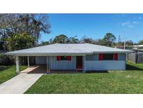 Charming single-story home with a covered carport and a well-maintained lawn at 96 New York Avenue, Dunedin, FL 34698