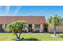 Charming single-story home featuring well-maintained landscaping and a unique terra cotta colored tile roof at 19029 Us Highway 19 N # 30H, Clearwater, FL 33764