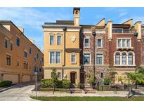 Stunning townhome showcasing a unique facade, neat landscaping, and inviting curb appeal at 2240 Soho Bay Ct, Tampa, FL 33606