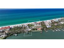 Stunning aerial view of a beachfront home with lush landscaping and private beach access at 2411 And 2407 Casey Key Rd, Nokomis, FL 34275