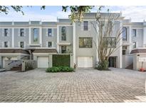 Charming townhomes featuring private garages, landscaped entrances, and brick paver driveways at 5010 Bayshore Blvd # 9, Tampa, FL 33611
