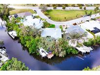 Stunning aerial view of waterfront home with boat dock, lush landscaping, and desirable coastal living at 809 30Th E Ct, Bradenton, FL 34208