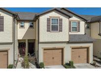 Charming townhouse with neutral siding, complemented by two-car garage at 9208 Hillcroft Dr, Riverview, FL 33578