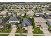 A beautiful aerial view of the house showing the neighborhood and roof top at 9244 Bella Vita Cir, Land O Lakes, FL 34637