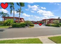 Attractive condos with manicured landscaping, tile roofs, and a common parking area at 10351 Regal Dr # 10, Largo, FL 33774