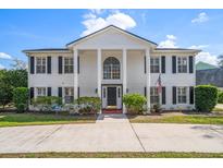 Stunning two-story home featuring a grand entrance with white columns and a manicured lawn at 2102 S Fore Cir, Tampa, FL 33612