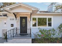 Charming front entry with black door, decorative glass, stone accents, and wrought iron railing at 2320 E Harbor S Dr, St Petersburg, FL 33705