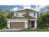 Charming two-story home with neutral siding, a two-car garage, and manicured landscaping at 757 Steel Dr, Apollo Beach, FL 33572