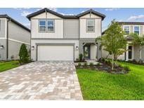 Charming two-story home with landscaped yard and paved driveway at 10356 Cross River Trl, Parrish, FL 34219